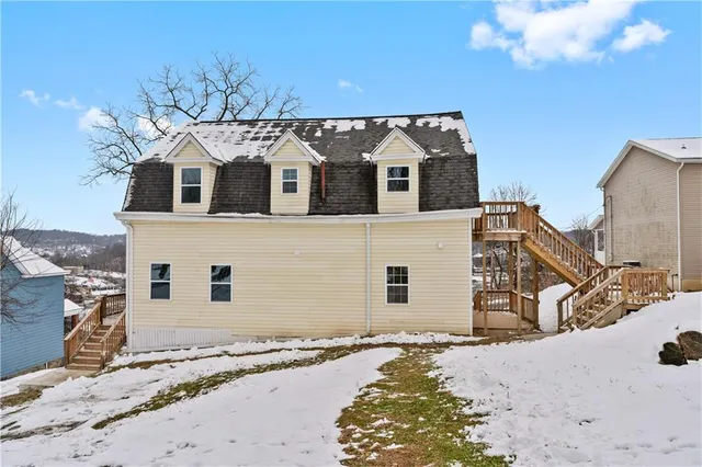 a view of a house with a wooden fence