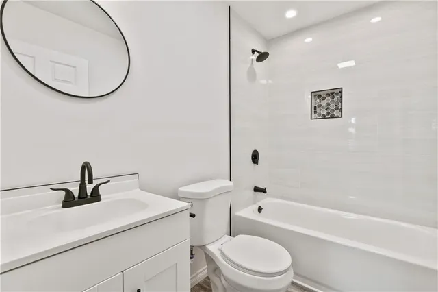 a bathroom with a toilet a sink and a bathtub