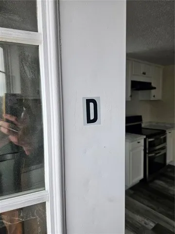 a kitchen with a refrigerator and white cabinets