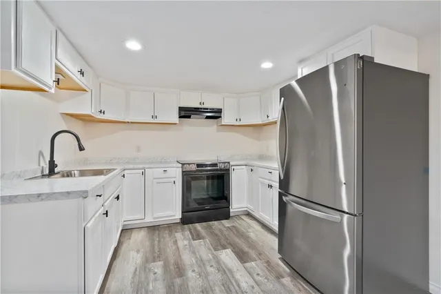 a kitchen with a refrigerator and a sink