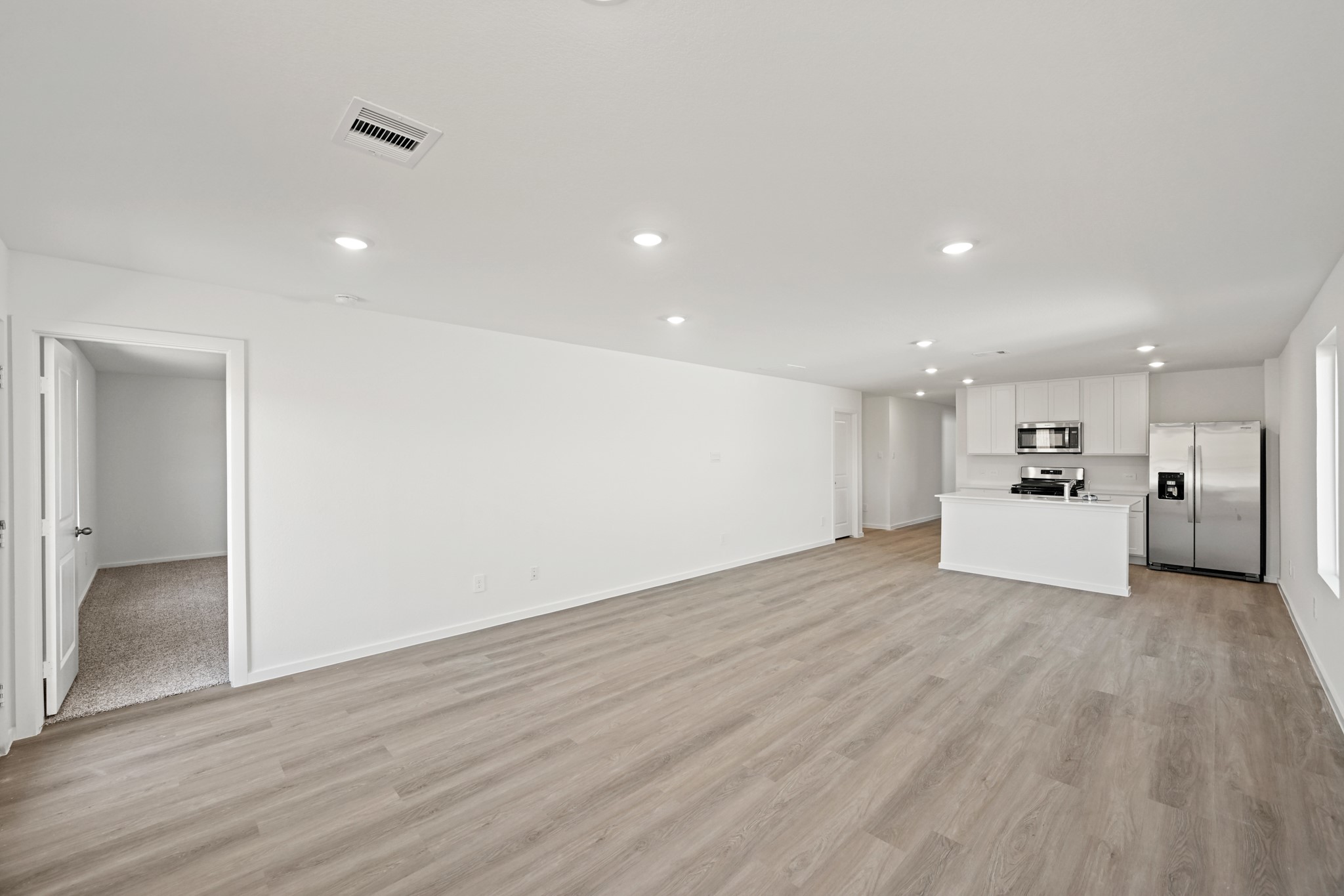 3032 Fall Gold Lane Katy, TX 77493 - Photo 6 of 24 a view of a kitchen with a sink dishwasher refrigerator and white cabinets