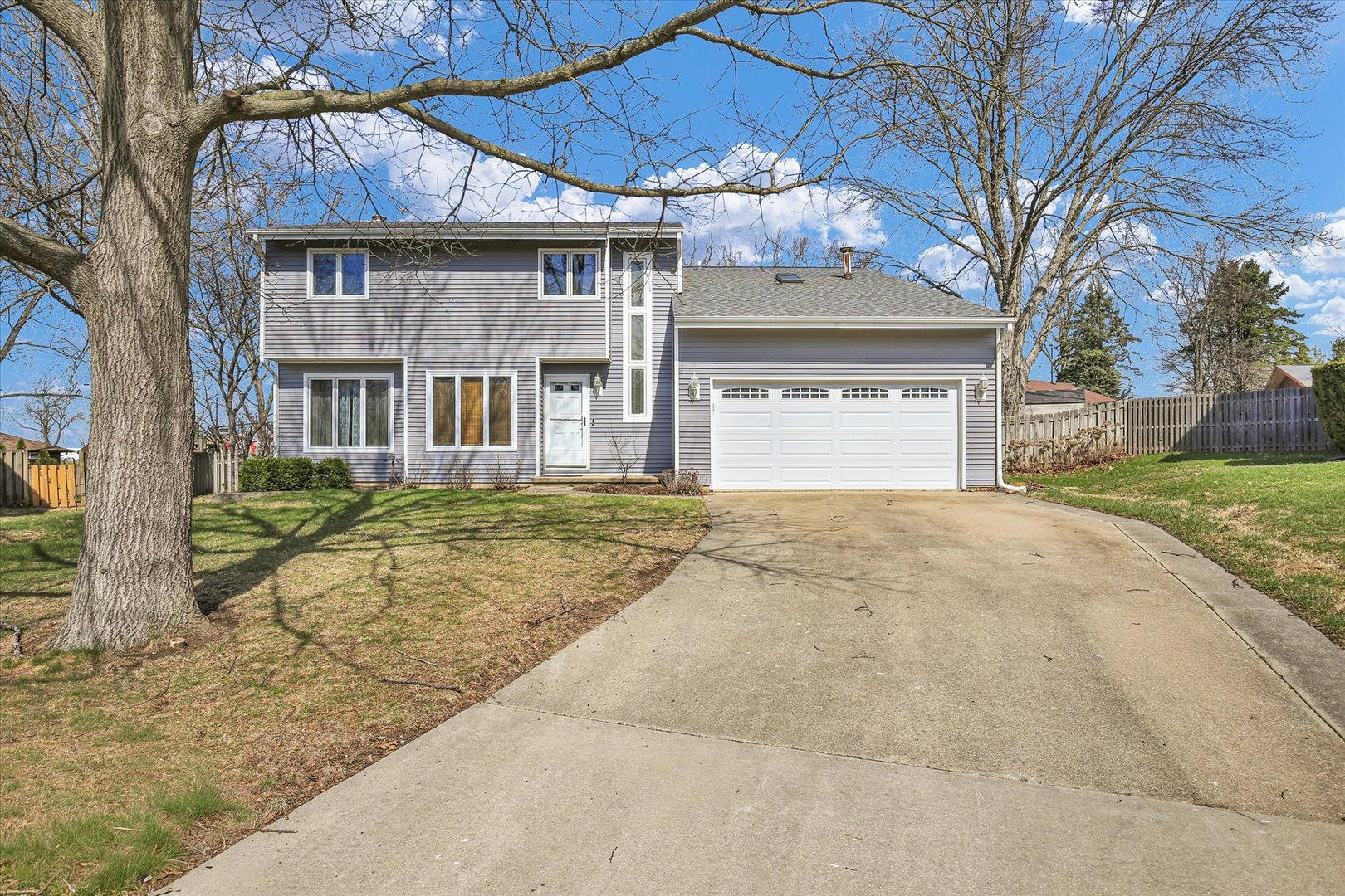 4 Genevieve Lane Champaign, IL 61822 - Photo 1 of 54 a front view of a house with a yard and garage