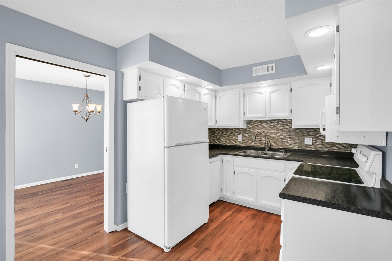 4 Genevieve Lane Champaign, IL 61822 - Photo 17 of 54 a kitchen with granite countertop a refrigerator and a stove