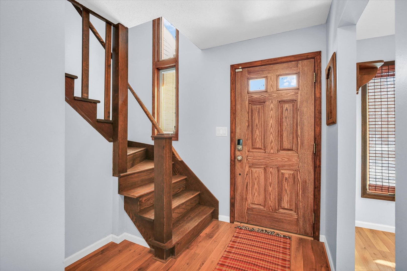 4 Genevieve Lane Champaign, IL 61822 - Photo 22 of 54 a view of front door with wooden floor and stairs