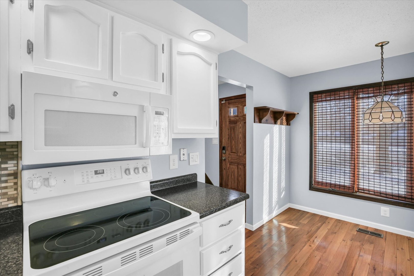 4 Genevieve Lane Champaign, IL 61822 - Photo 24 of 54 a kitchen with granite countertop white cabinets and white appliances