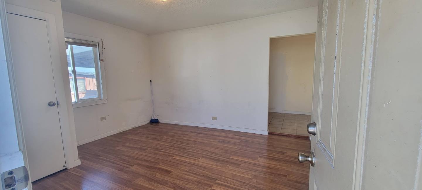 368 Roberts Avenue Seaside, CA 93955 - Photo 4 of 14 a view of an empty room with wooden floor and a window