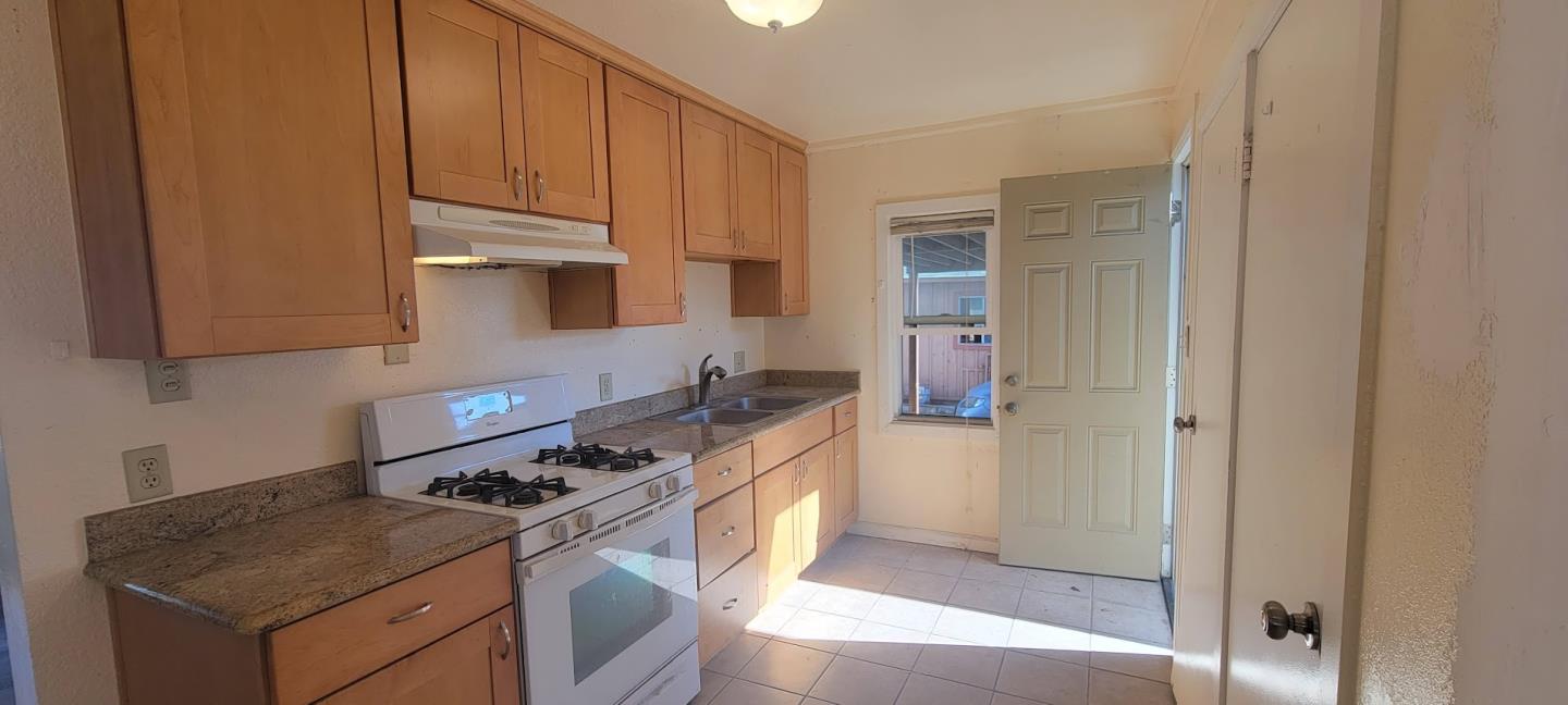 368 Roberts Avenue Seaside, CA 93955 - Photo 5 of 14 a kitchen with stainless steel appliances granite countertop a stove and a refrigerator
