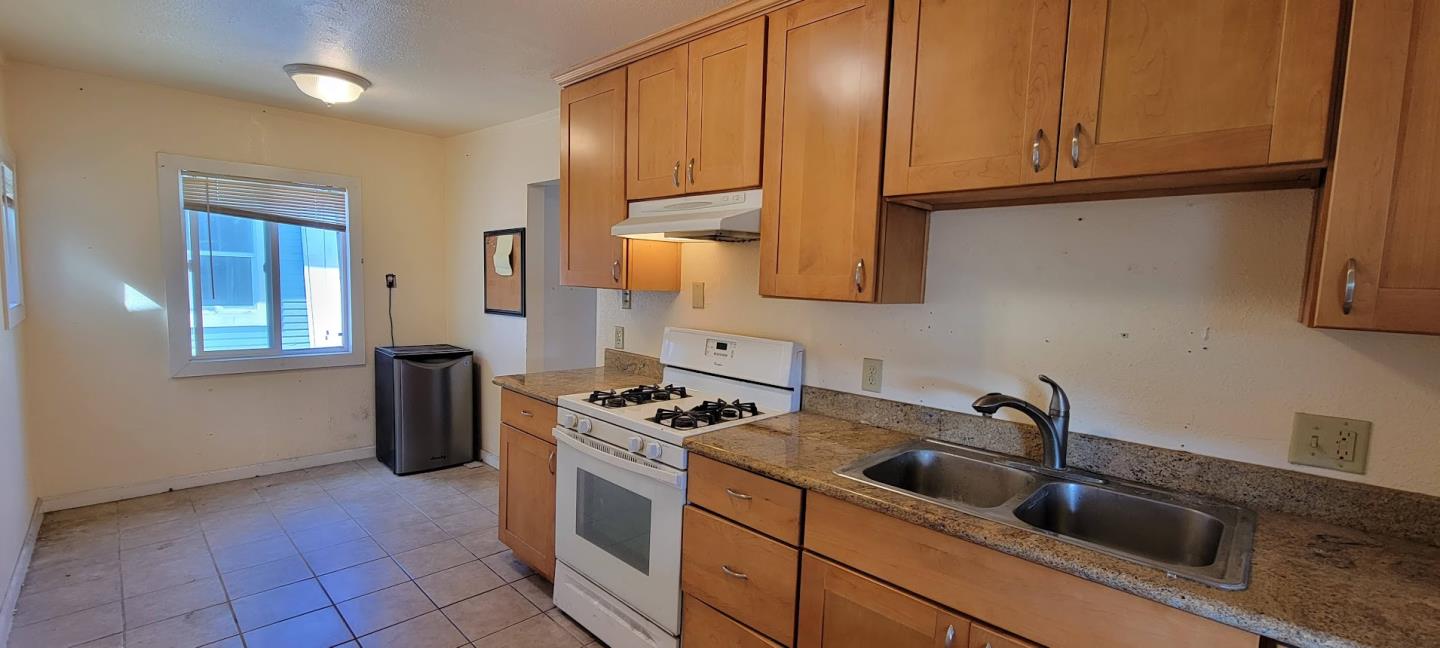 368 Roberts Avenue Seaside, CA 93955 - Photo 6 of 14 a kitchen with stainless steel appliances granite countertop a sink a stove and a refrigerator