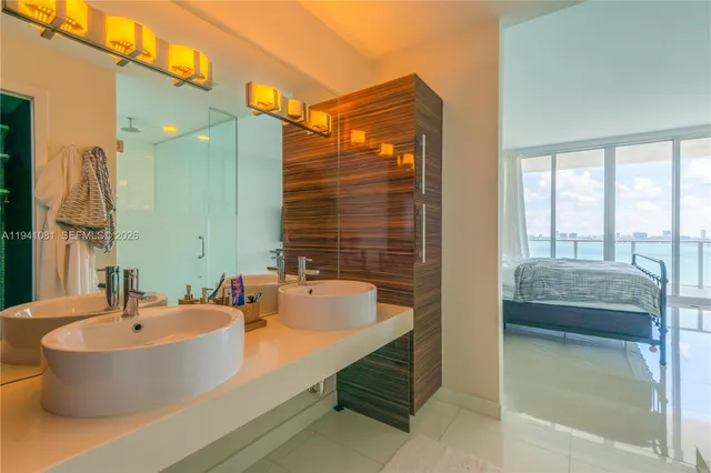 a bathroom with a tub a sink and a large mirror