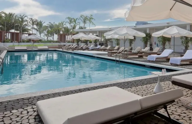 a view of swimming pool with outdoor seating