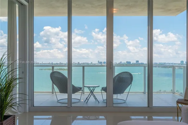a view of a room with a table and chairs