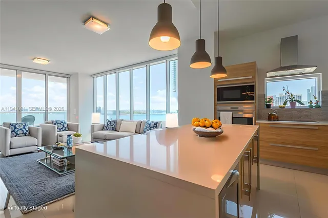 a dining room with furniture and a large window