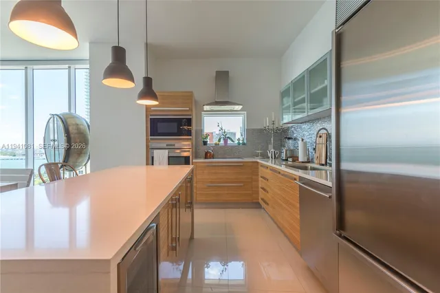 a kitchen with stainless steel appliances granite countertop a sink and stove
