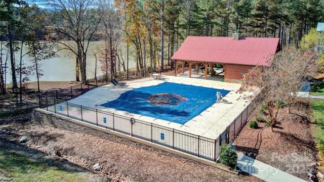 a view of a backyard with a garden and fire pit