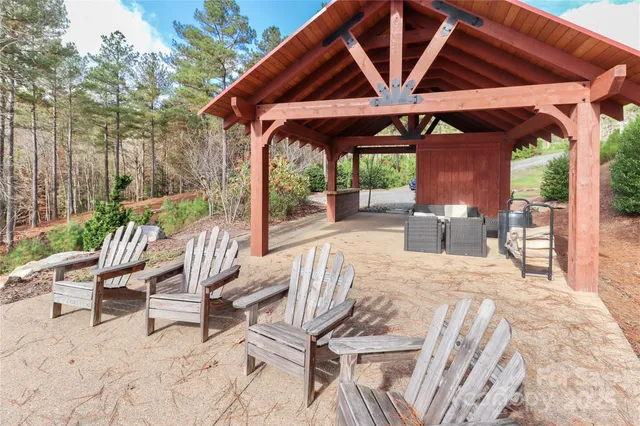 a view of a lake with table and chairs
