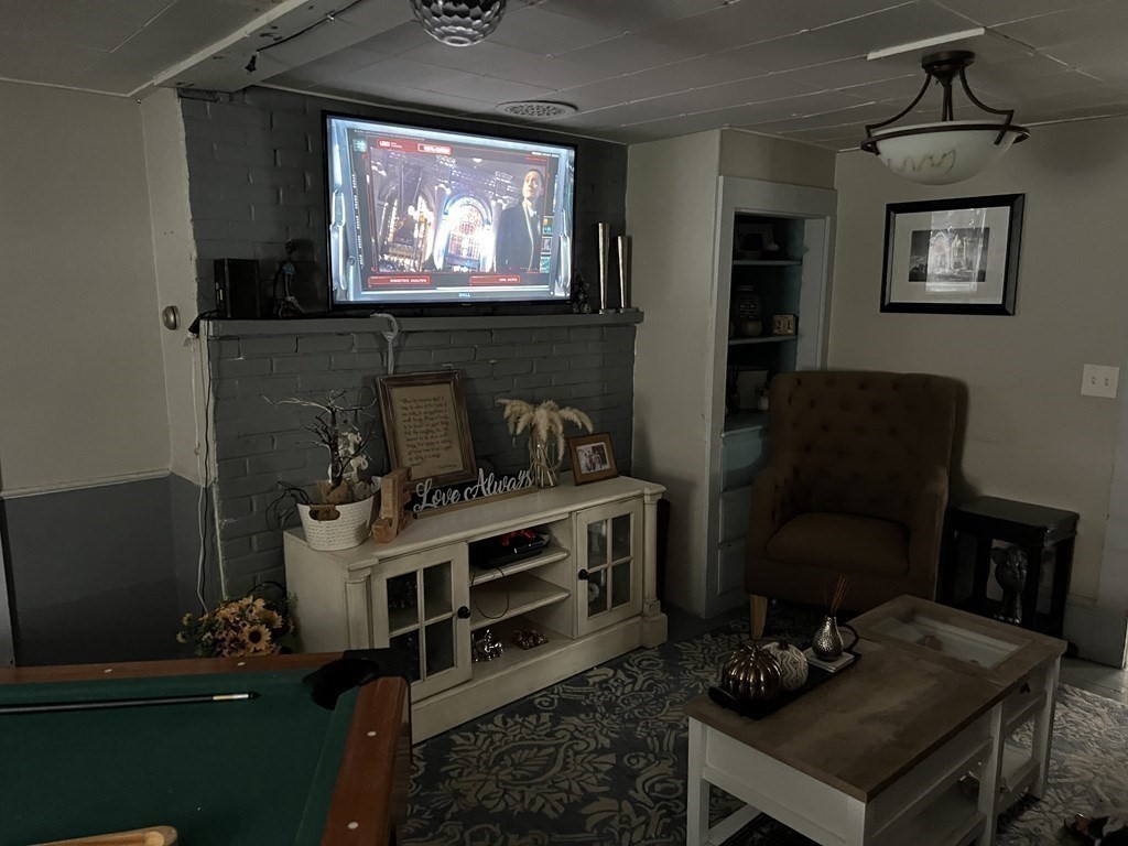 601 Main Street Bolton, MA 01740 - Photo 11 of 22 a living room with furniture a flat screen tv and a fireplace