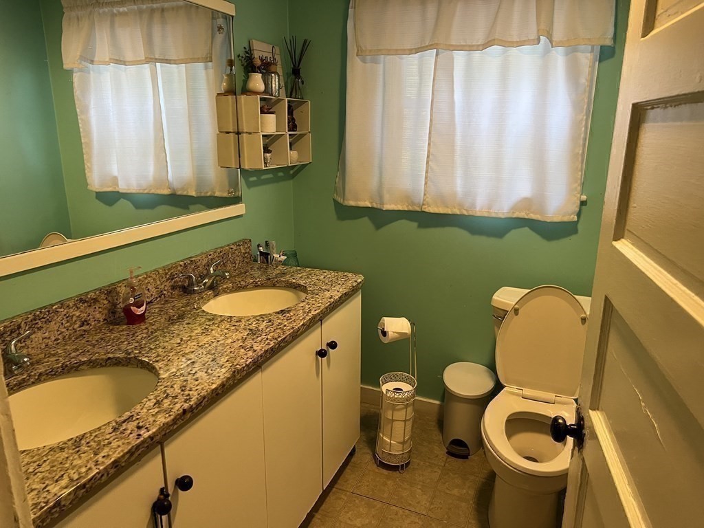 601 Main Street Bolton, MA 01740 - Photo 19 of 22 a bathroom with a granite countertop sink and a mirror