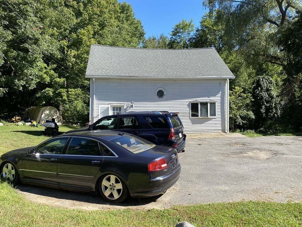 601 Main Street Bolton, MA 01740 - Photo 3 of 22 a car parked in front of a house