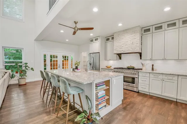 a kitchen with stainless steel appliances granite countertop a lot of counter space and a refrigerator