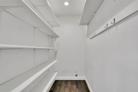 a view of walk in closet with empty racks