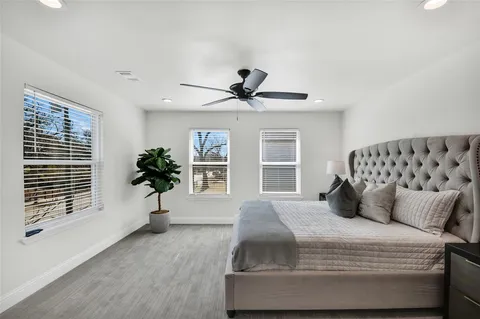 a bedroom with a large bed and a window