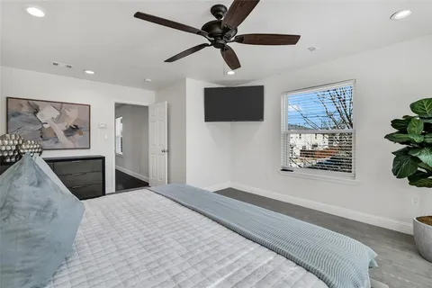 a bedroom with a bed and a painting on the wall