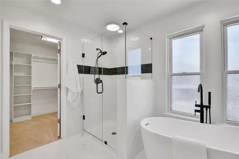 a bathroom with a bathtub and a shower