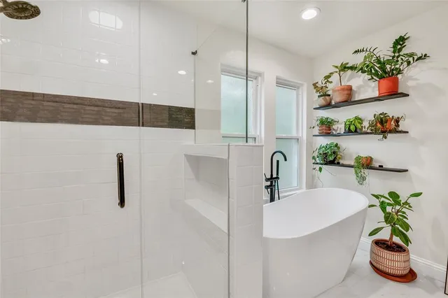 a bathroom with double vanity and a mirror