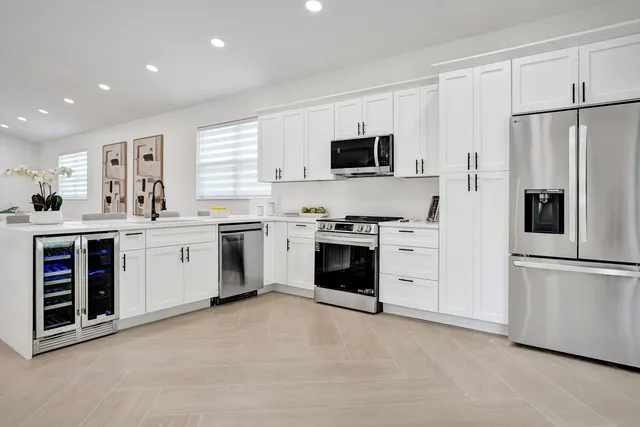 a large white bed in a white room