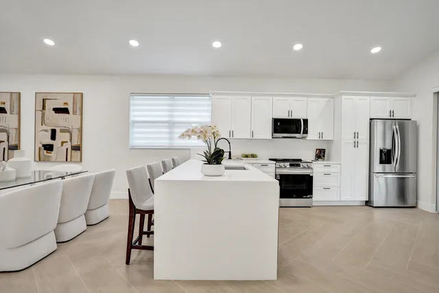a bedroom with a bed and a lamp on dresser