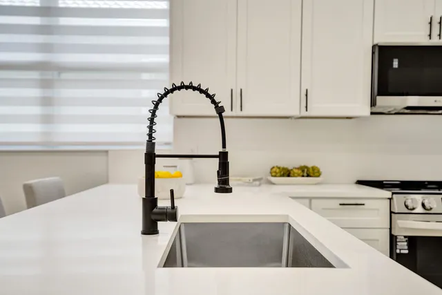 a bathroom with a double vanity sink mirror and shower