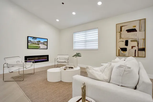 a kitchen with stainless steel appliances granite countertop a stove top oven a sink dishwasher and a refrigerator with wooden floor