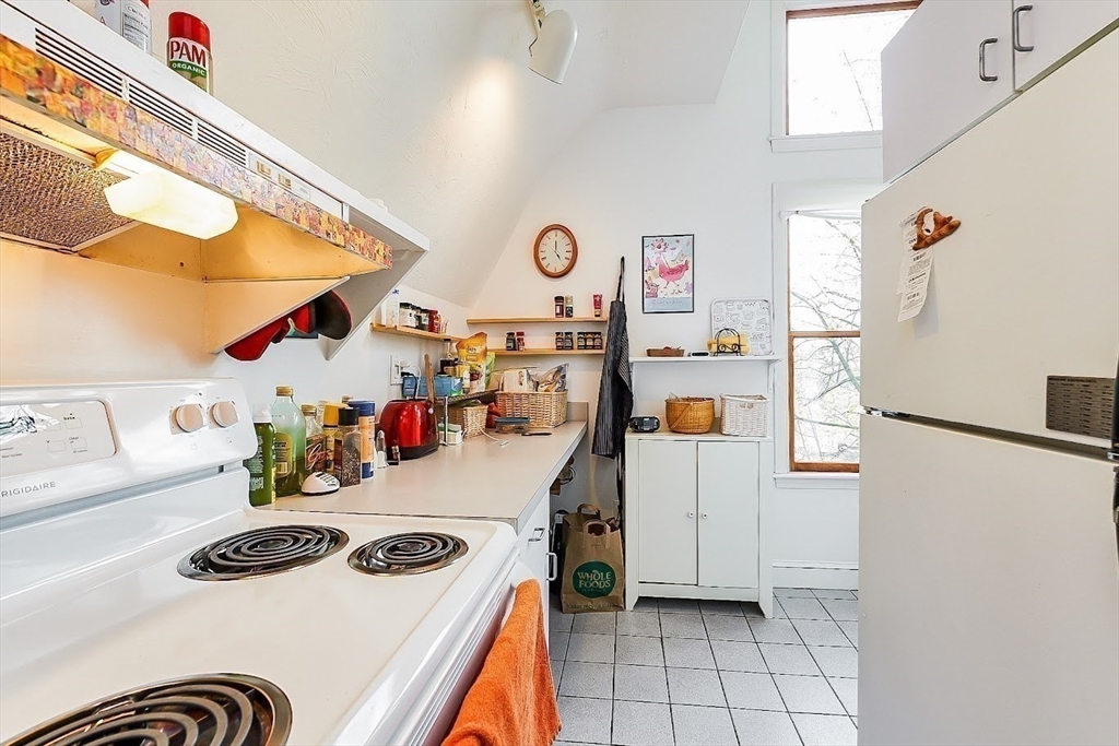 32 Mason Terrace, Unit 2 Brookline, MA 02446 - Photo 11 of 18 a kitchen with a refrigerator and a stove