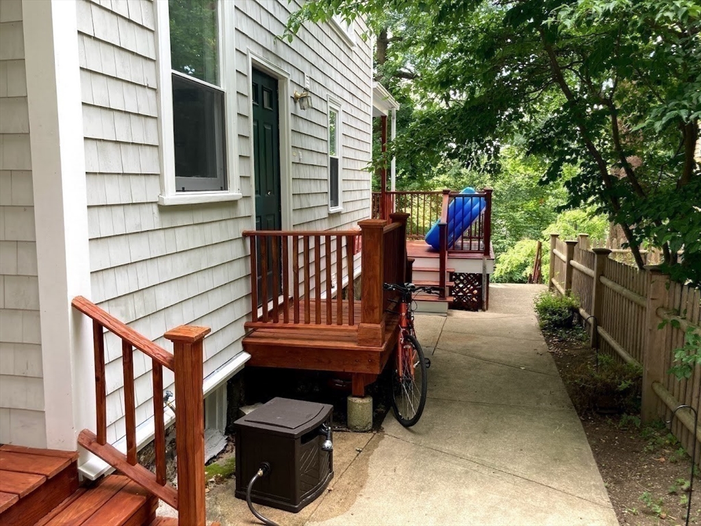 32 Mason Terrace, Unit 2 Brookline, MA 02446 - Photo 14 of 18 a view of a chairs and tables in the back yard of the house