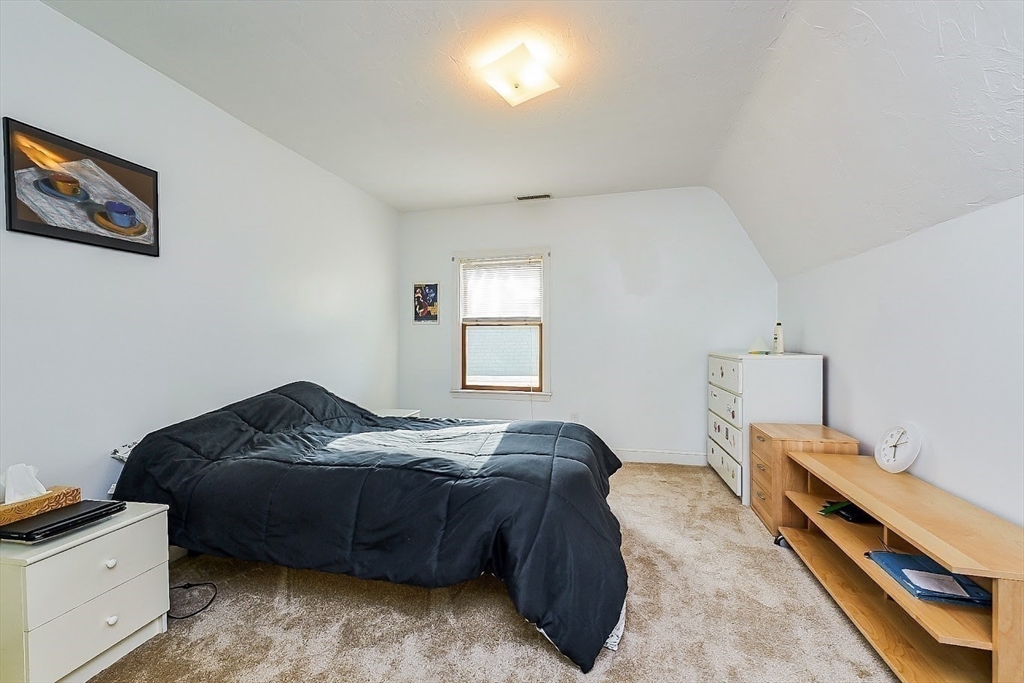 32 Mason Terrace, Unit 2 Brookline, MA 02446 - Photo 7 of 18 a bedroom with a bed and a window