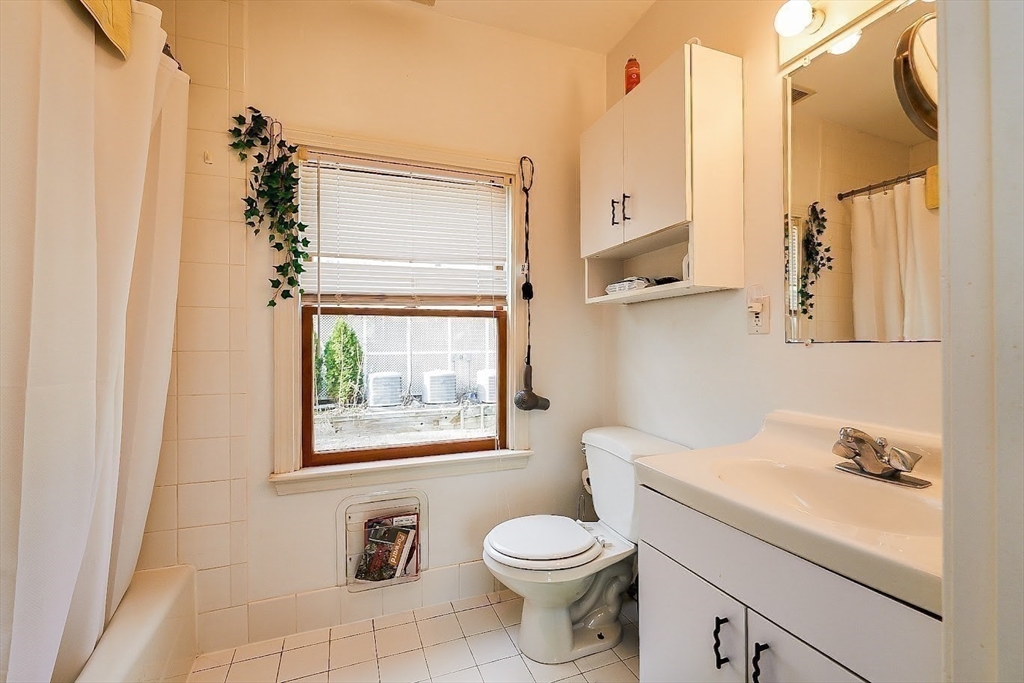 32 Mason Terrace, Unit 2 Brookline, MA 02446 - Photo 9 of 18 a bathroom with a toilet sink and mirror
