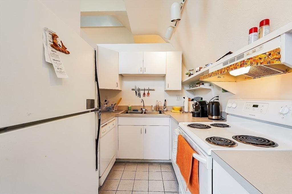 32 Mason Terrace, Unit 2 Brookline, MA 02446 - Photo 10 of 18 a kitchen with a sink a stove and refrigerator
