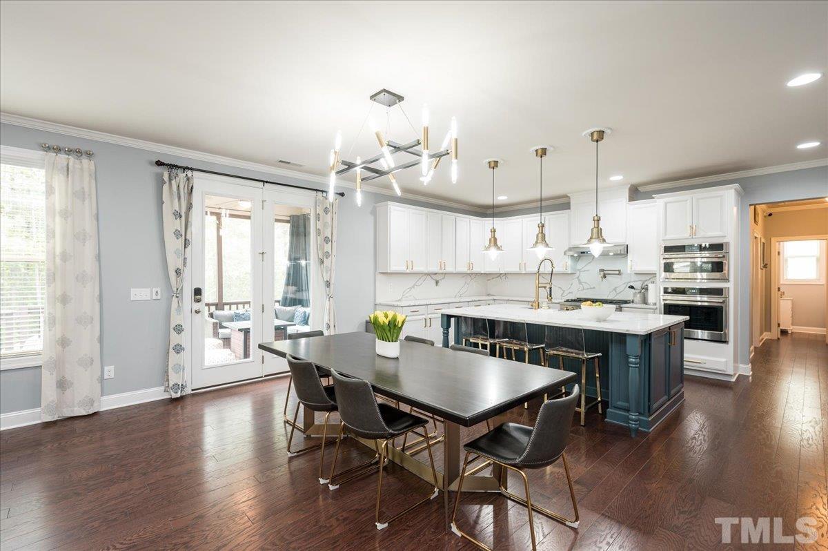 8317 Henderson Road Apex, NC 27539 - Photo 13 of 31 a view of a dining room with furniture and wooden floor