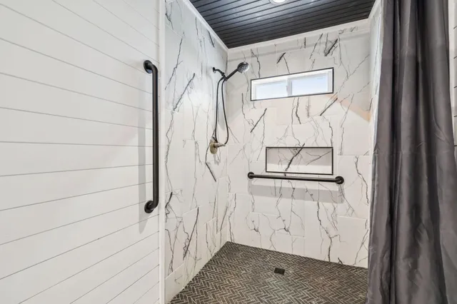 a bathroom with a glass shower door