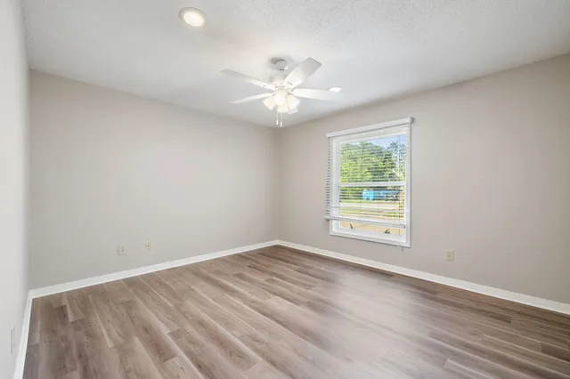 a bed room with a bed and a chair