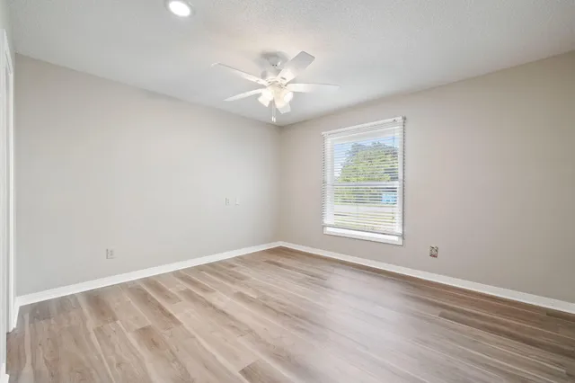 a bedroom with a bed and chair