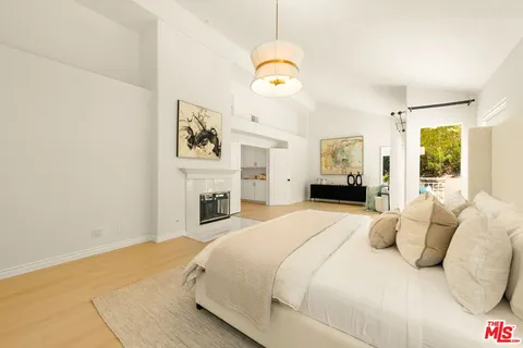 a bedroom with a bed and a chandelier