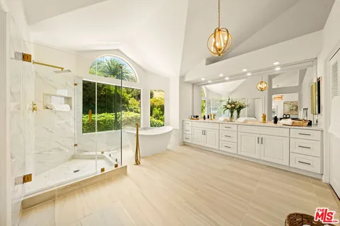 a large bathroom with a large tub and shower