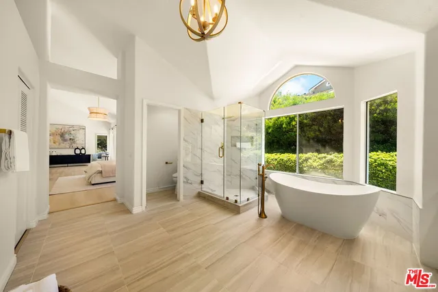 a bathroom with a tub and a view of bathroom