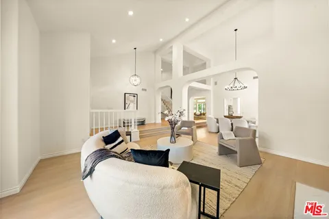 a living room with couches chairs and fireplace