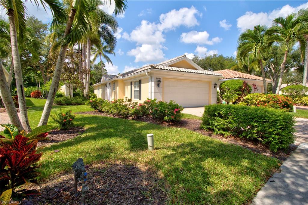 6092 Andros Way Naples, FL 34119 - Photo 1 of 21 a front view of a house with garden