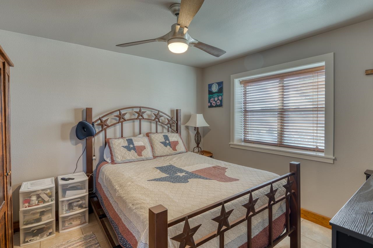352 Keller Velino Road Mason, TX 76856 - Photo 14 of 25 a bedroom with a bed and a window