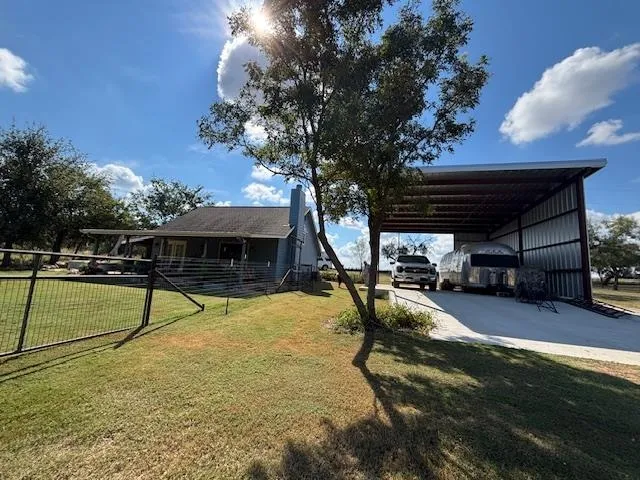 a swimming pool with outdoor seating and yard