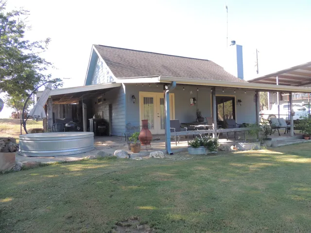 a view of a house with swimming pool and sitting area