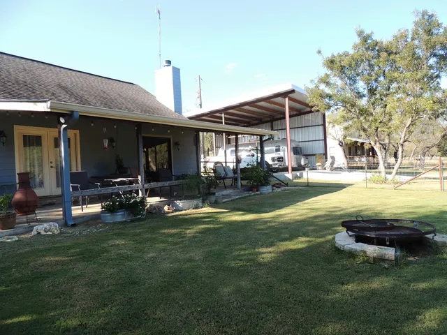 a view of a house with swimming pool and a yard